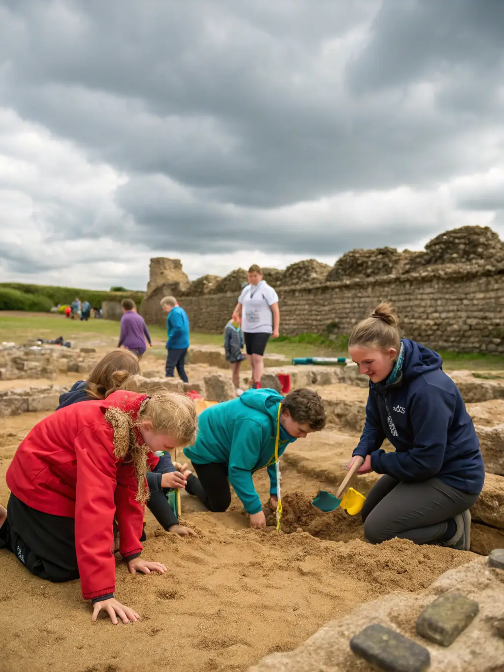 A photograph capturing children participating in an archaeological dig at the Gallo-Roman sanctuary, supervised by an archaeologist, showcasing hands-on learning.